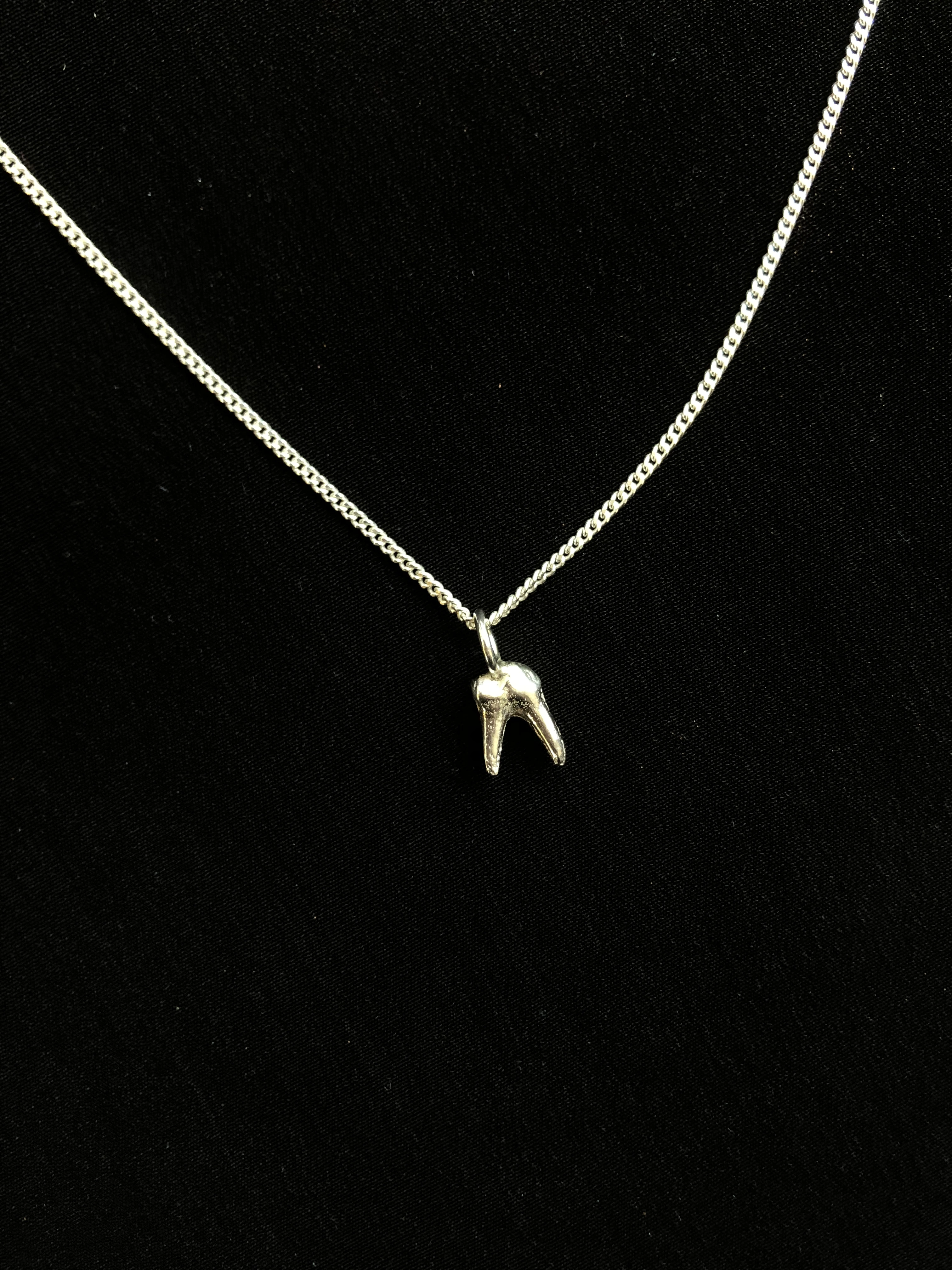 Tooth charm on chain